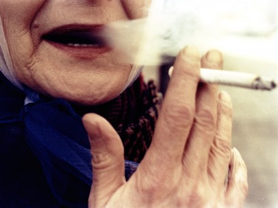 Woman with red lips smoking, 1975
