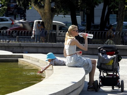 Una mujer bebe agua para refrescarse en Madrid
