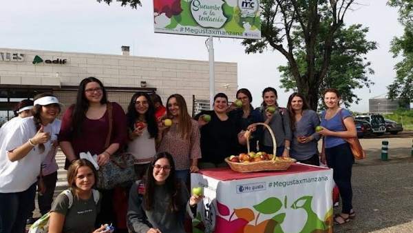 Un grupo de alumnos reciben su manzana Un grupo de alumnos reciben su manzana