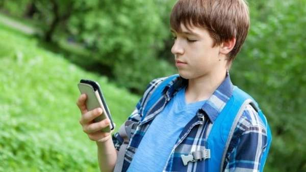 Niño utilizando un teléfono móvil Niño utilizando un teléfono móvil