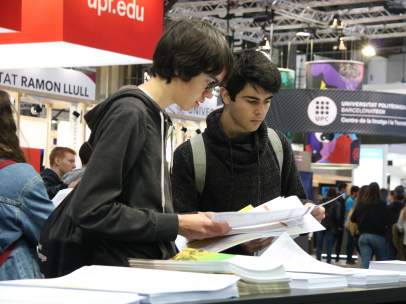 Dos jóvenes consultando la oferta universitaria en el Saló de l'Ensenyament.
