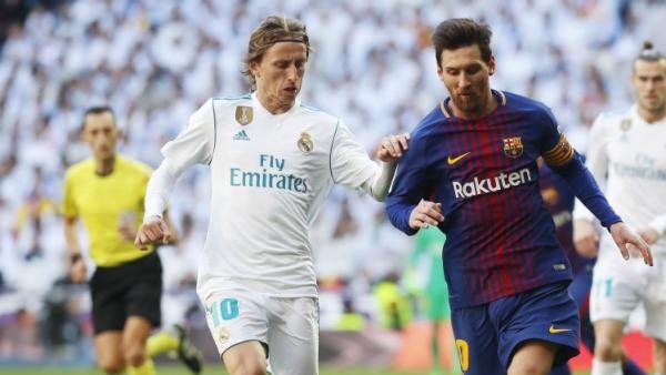 Luka Modric y Leo Messi disputan un balón en el clásico Luka Modric y Leo Messi disputan un balón en el clásico