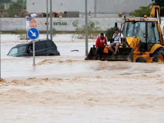 Dos ocupantes de un vehículo son rescatados por una pala mecánica en Orihuela
